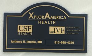 Exterior routed (sandblasted) outdoor custom sign for Xplor America. Sign has two removable plaques.