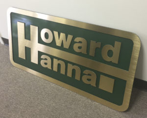 Howard Hanna routed sign with gold face and green background