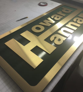 Howard Hanna Routed sign with gold face and green background